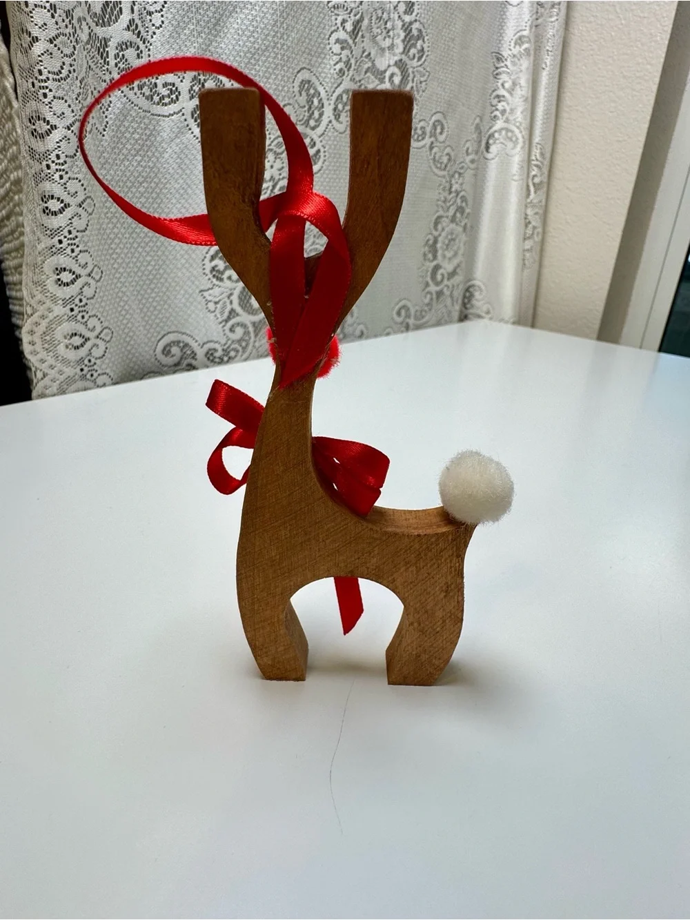 Homemade Wooden Reindeer Holiday Décor with Red Ribbon and Pom-Poms